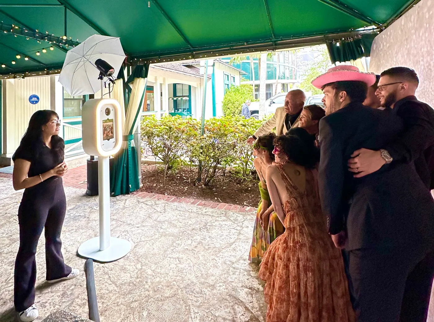 Guests at an outdoor garden party photo booth