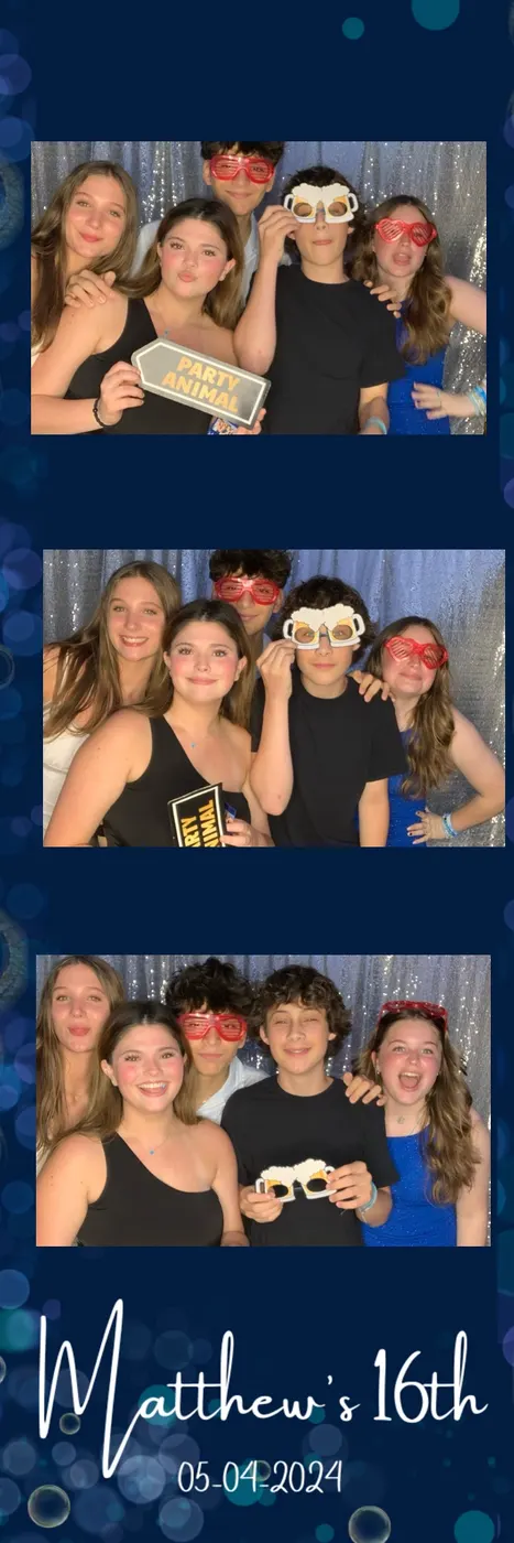 Students posing with props at a photo booth